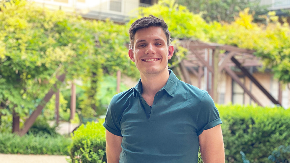 Jacob Cheek, deaf gay man smiles in blue shirt while outside telling his story